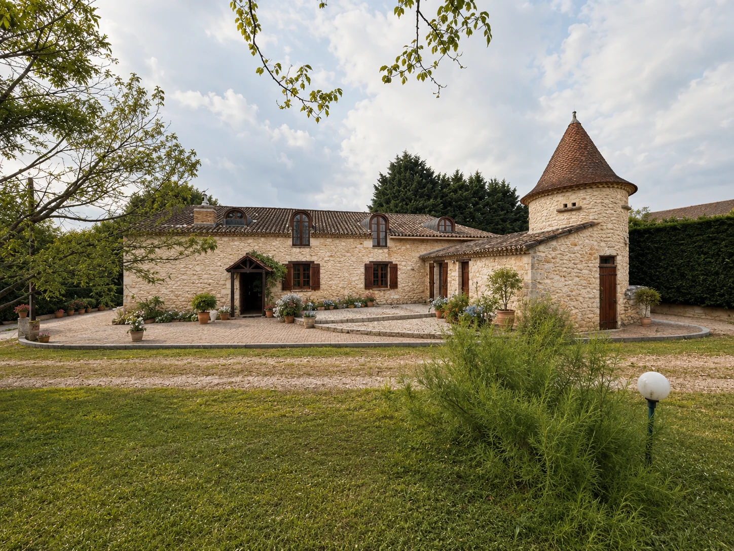 La Grâce farmhouse frontage with pigeonnier tower and restored stone terrace